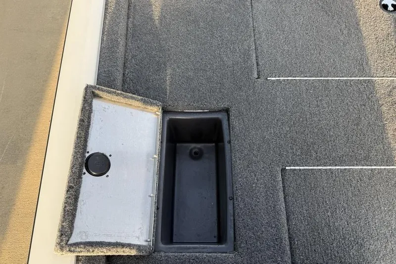 Slide: The Image of 2022 Tracker Pro Team 175 TXW boat storage compartment with open lid. - 17