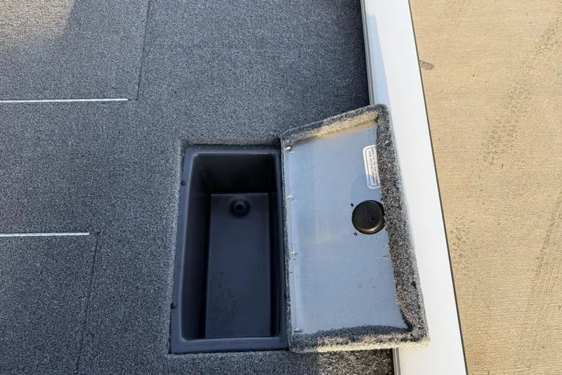 Slide: The Image of 2022 Tracker Pro Team 175 TXW boat storage compartment with open lid. - 18