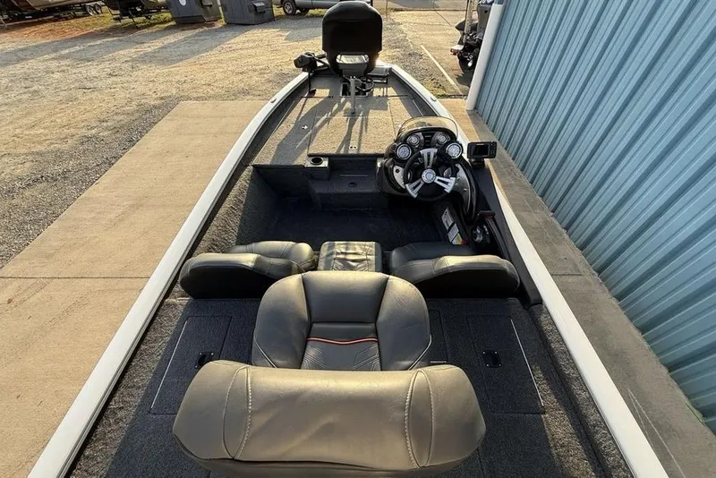 Slide: The Image of 2022 Tracker Pro Team 175 TXW boat interior with steering console and seating. - 24