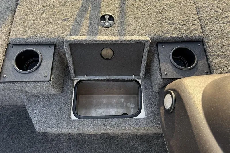 Slide: The Image of 2022 Tracker Pro Team 175 TXW boat interior with storage compartment and cup holders. - 13