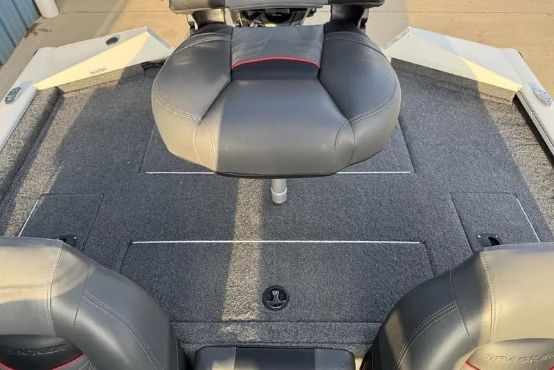 Slide: The Image of 2022 Tracker Pro Team 175 TXW boat interior with cushioned seating and carpeted deck. - 20