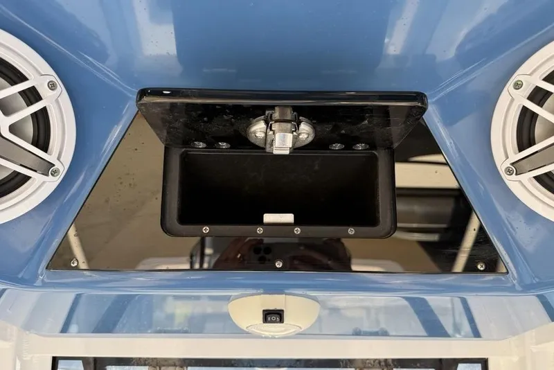 Slide: The Image of 2022 Sportsman Masters 247OE Bay Boat dashboard with speakers and storage compartment. - 11