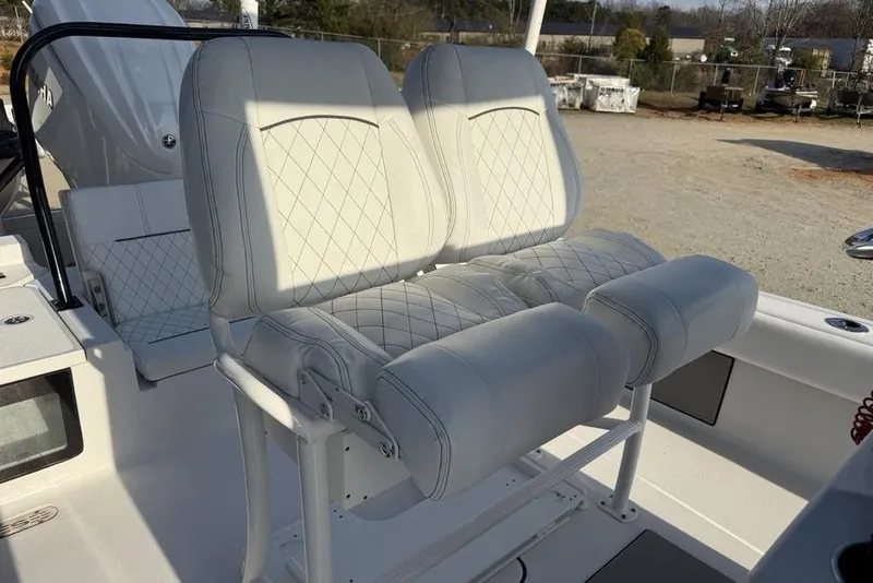 Slide: The Image of Luxurious seating on 2022 Sportsman Masters 247OE Bay Boat, featuring white cushioned seats. - 13