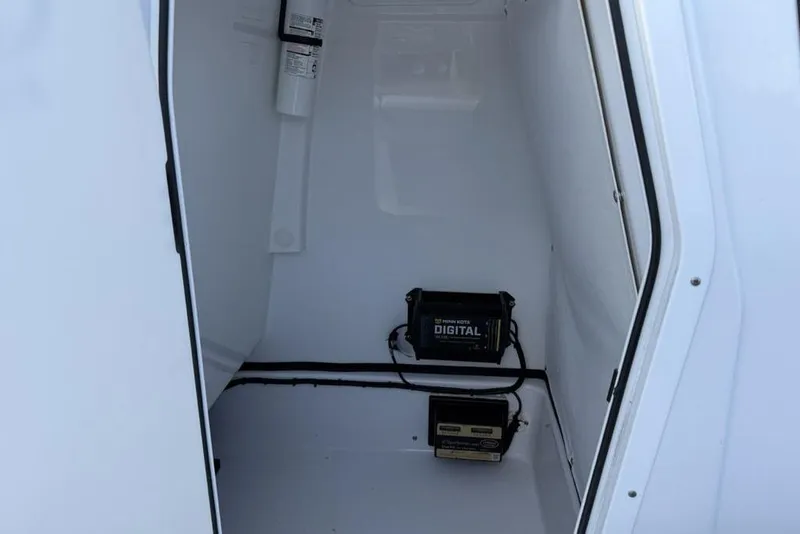 Slide: The Image of 2022 Sportsman Masters 247OE Bay Boat storage compartment with digital equipment. - 17