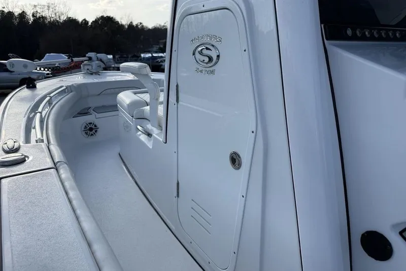 Slide: The Image of 2022 Sportsman Masters 247OE Bay Boat, white interior, sleek design, side view. - 19