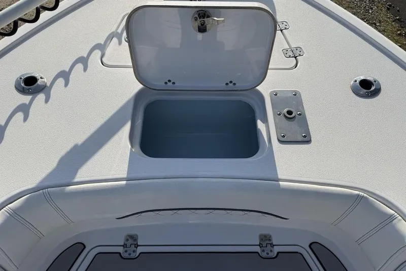 Slide: The Image of 2022 Sportsman Masters 247OE Bay Boat deck with open storage compartment. - 2
