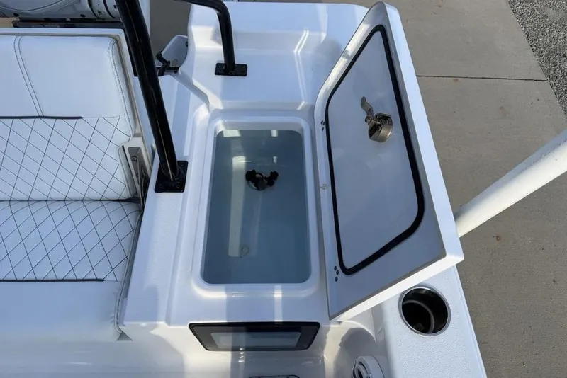 Slide: The Image of 2022 Sportsman Masters 247OE Bay Boat livewell with open lid and seating area. - 20