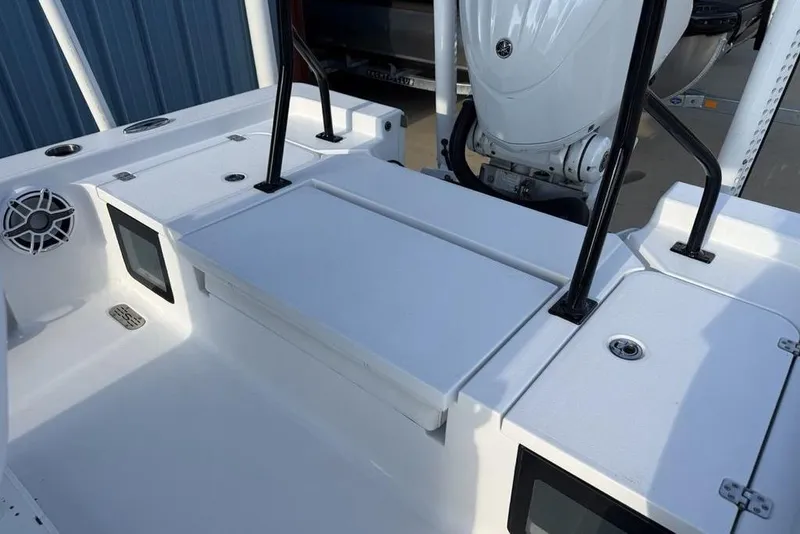 Slide: The Image of 2022 Sportsman Masters 247OE Bay Boat interior with storage compartments and engine view. - 22