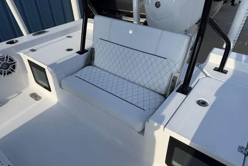 Slide: The Image of 2022 Sportsman Masters 247OE Bay Boat interior with white seating and modern features. - 23