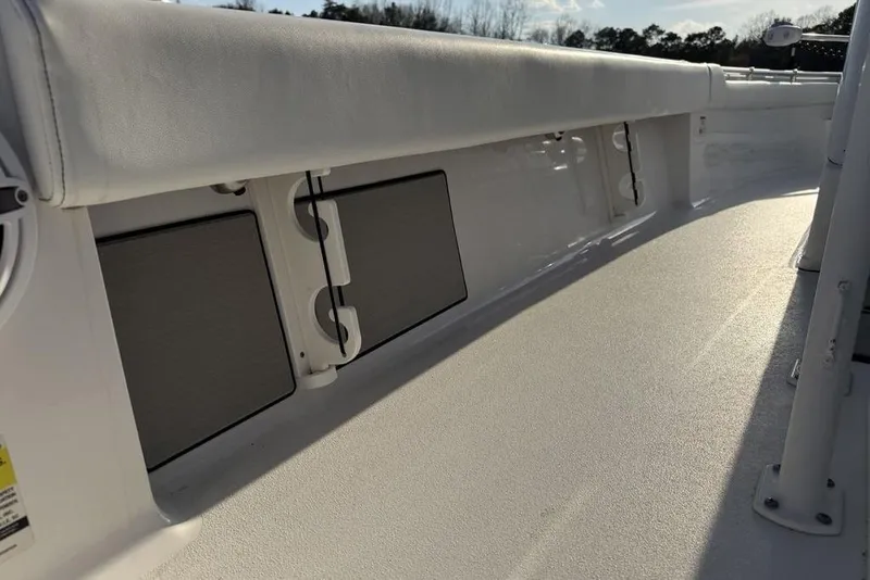 Slide: The Image of 2022 Sportsman Masters 247OE Bay Boat interior, featuring sleek white seating and storage compartments. - 25