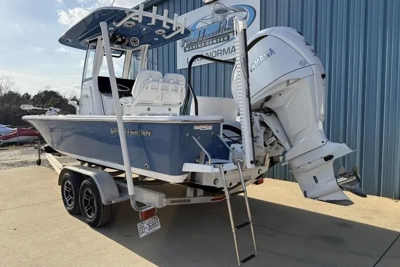 Slide: The Image of 2022 Sportsman Masters 247OE Bay Boat on trailer, blue hull, Yamaha outboard engine. - 3