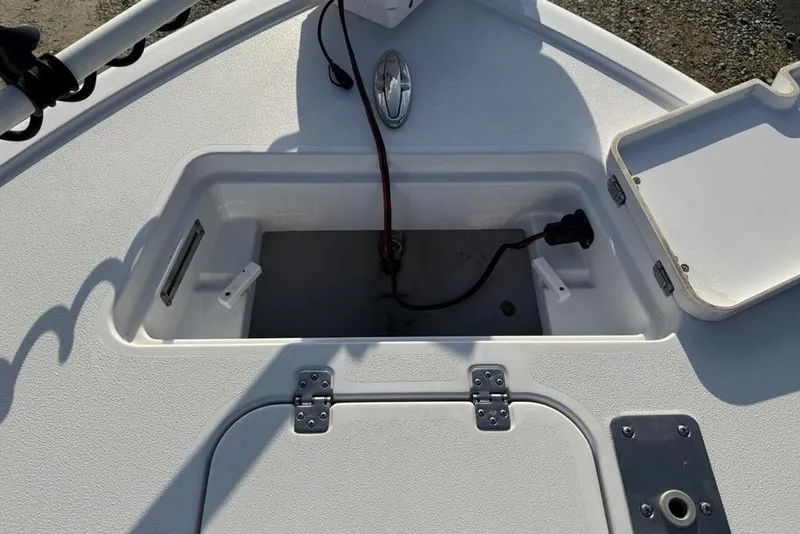 Slide: The Image of 2022 Sportsman Masters 247OE Bay Boat storage compartment with open hatch and wiring. - 32