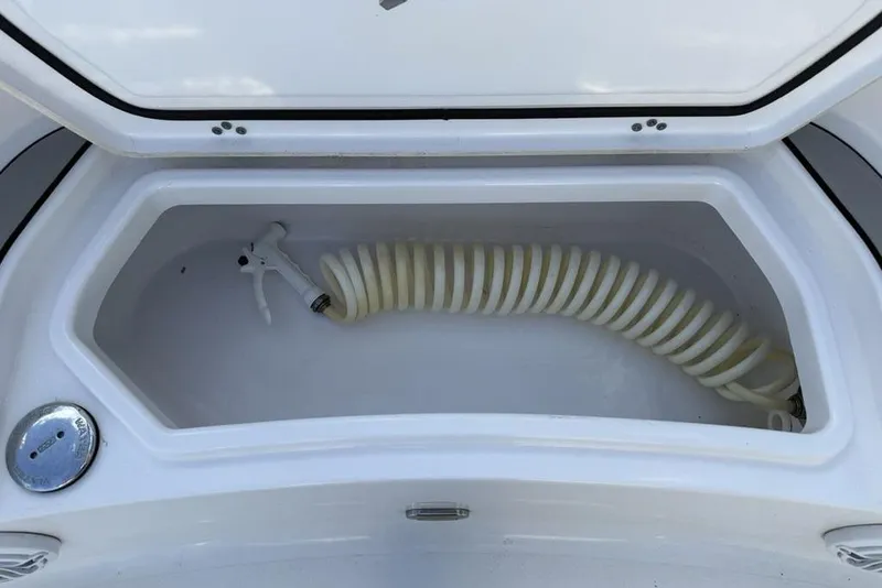 Slide: The Image of Storage compartment with coiled hose on 2022 Sportsman Masters 247OE Bay Boat. - 6