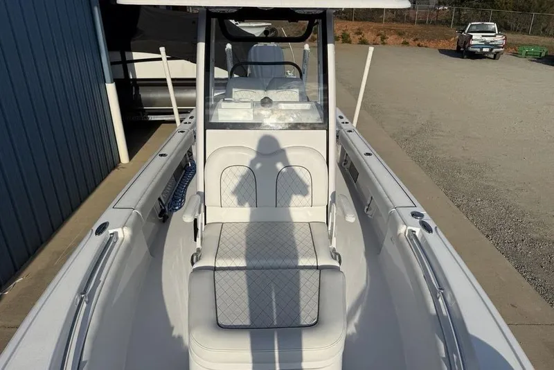 Slide: The Image of 2022 Sportsman Masters 247OE Bay Boat interior with seating and console view. - 7
