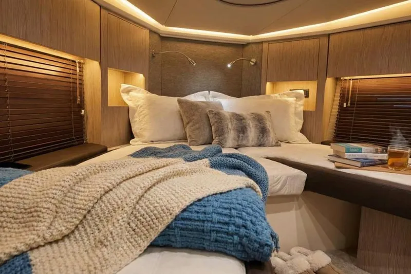 Slide: The Image of Luxurious 2024 Sessa Marine C44 Cruiser cabin with cozy bedding and ambient lighting. - 18