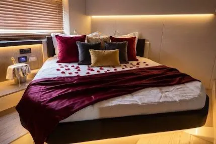 Slide: The Image of Luxurious bedroom in 2024 Sessa Marine C44 Cruiser with elegant decor and ambient lighting. - 19