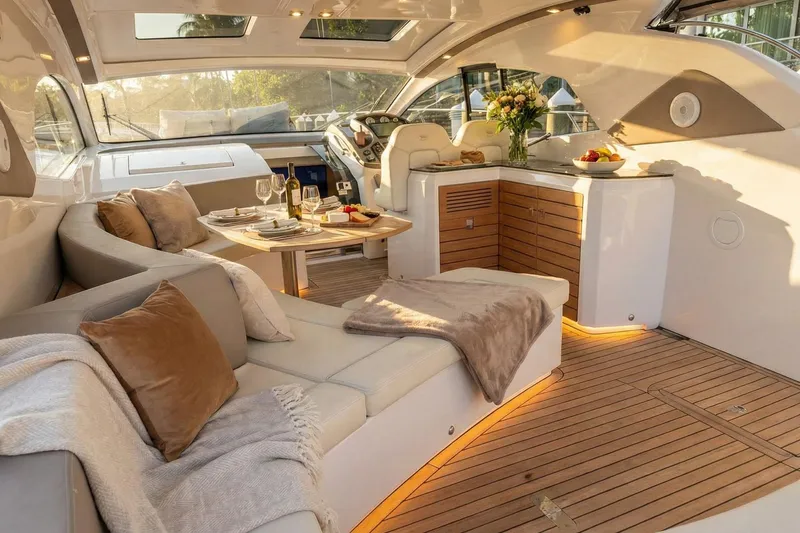 Slide: The Image of Luxurious interior of 2024 Sessa Marine C44 Cruiser with elegant seating and dining area. - 21