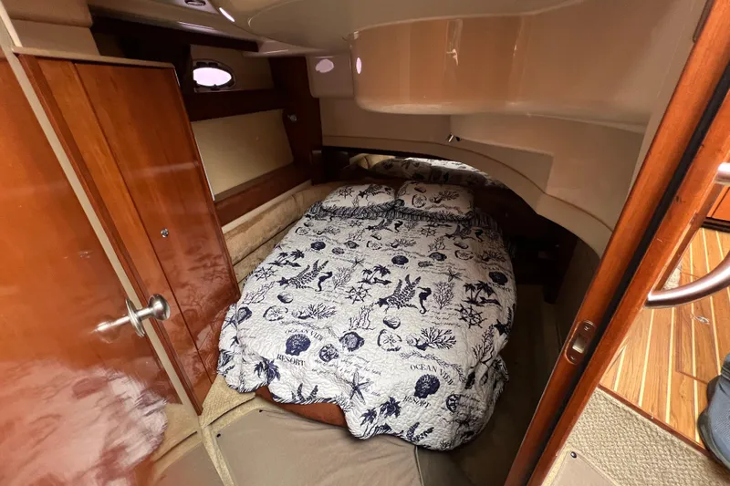Slide: The Image of Cozy cabin interior of 2007 Meridian 391 Sedan with nautical-themed bedding. - 15