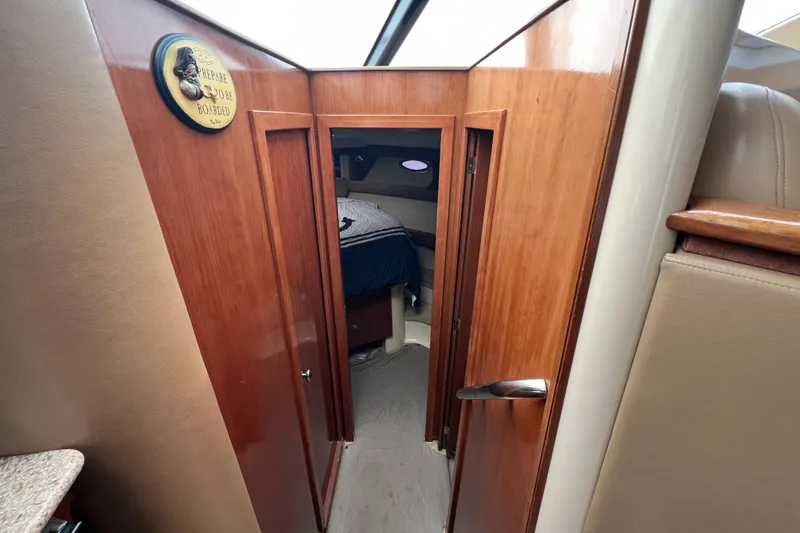 Slide: The Image of Interior cabin view of 2007 Meridian 391 Sedan yacht with wooden doors and cozy bedroom. - 16