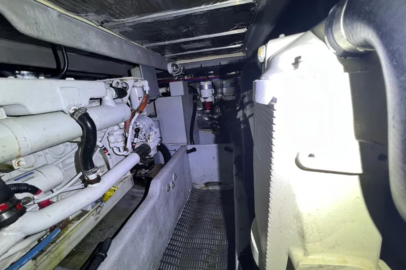 Slide: The Image of Engine room of a 2007 Meridian 391 Sedan yacht, showcasing mechanical components and piping. - 31