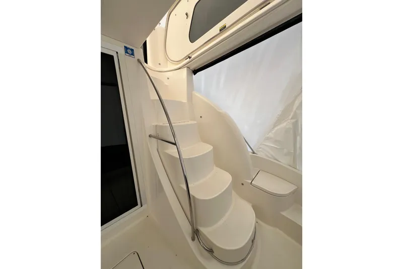 Slide: The Image of Interior staircase of 2007 Meridian 391 Sedan yacht, featuring sleek white design. - 35