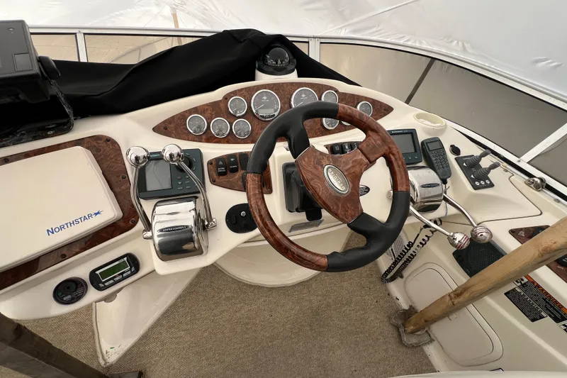Slide: The Image of 2007 Meridian 391 Sedan helm with wood-accented steering wheel and navigation controls. - 42