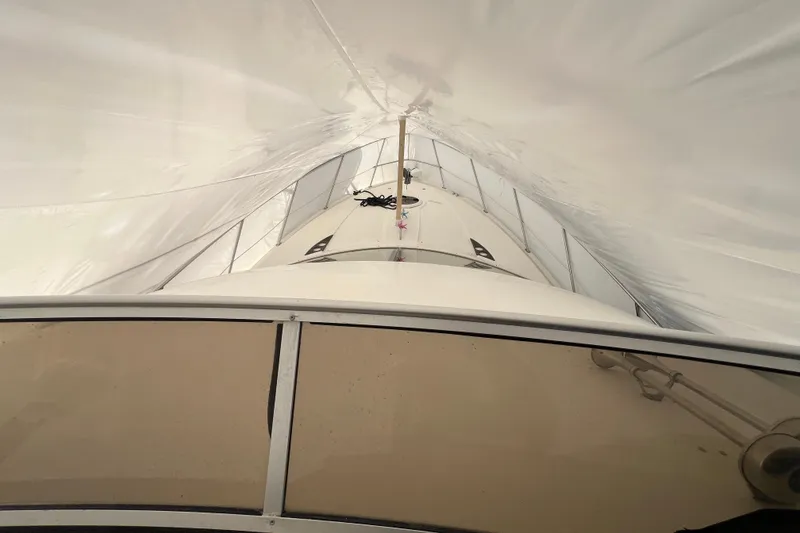 Slide: The Image of 2007 Meridian 391 Sedan yacht under protective cover, viewed from above. - 44