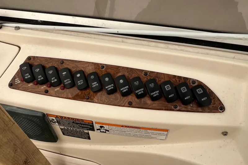 Slide: The Image of Control panel of a 2007 Meridian 391 Sedan boat with labeled switches. - 45