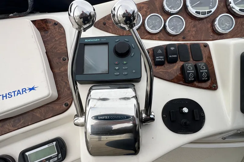 Slide: The Image of Control panel of a 2007 Meridian 391 Sedan boat with navigation and engine controls. - 49