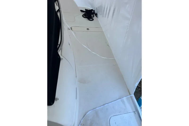 Slide: The Image of 2007 Meridian 391 Sedan boat deck with white flooring and coiled rope. - 52