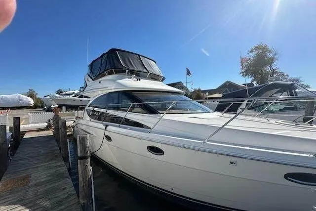 Slide: The Image of Luxurious cabin interior of 2007 Meridian 391 Sedan yacht with nautical-themed bedding. - 9