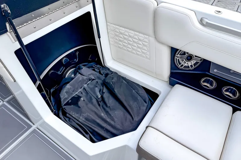 Slide: The Image of Ingenity EL 2026 boat interior with storage compartment and white seating. - 18