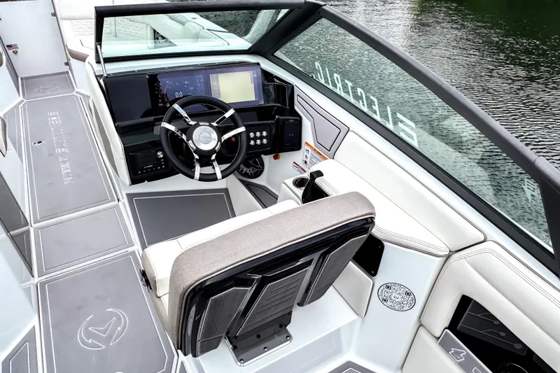 Slide: The Image of 2026 Ingenity EL boat cockpit with modern steering and digital controls on a serene water backdrop. - 7