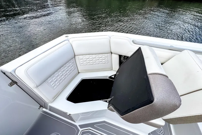 Slide: The Image of 2026 Ingenity EL boat interior with white cushioned seating and storage compartment. - 17