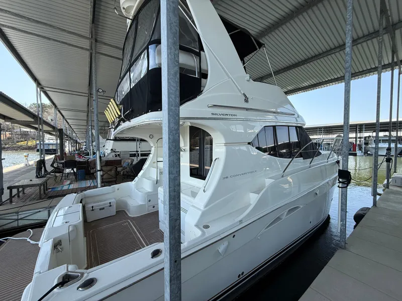 Slide: The Image of 2007 Silverton 36 Convertible yacht docked under a covered marina. - 22