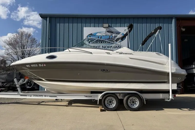 The Image of 2007 Sea Ray Sundancer 540 boat on trailer outside a marine center. - 0