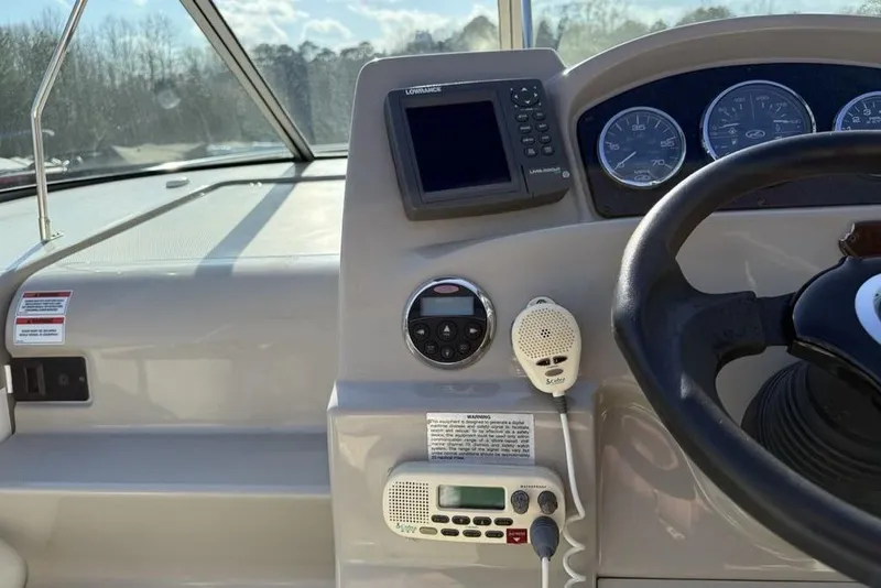 Slide: The Image of 2007 Sea Ray Sundancer 540 helm with steering wheel, gauges, and navigation equipment. - 11