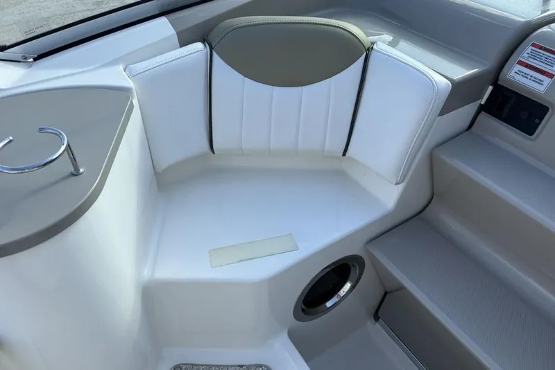 Slide: The Image of 2007 Sea Ray Sundancer 540 interior seating area with white upholstery and cup holder. - 18