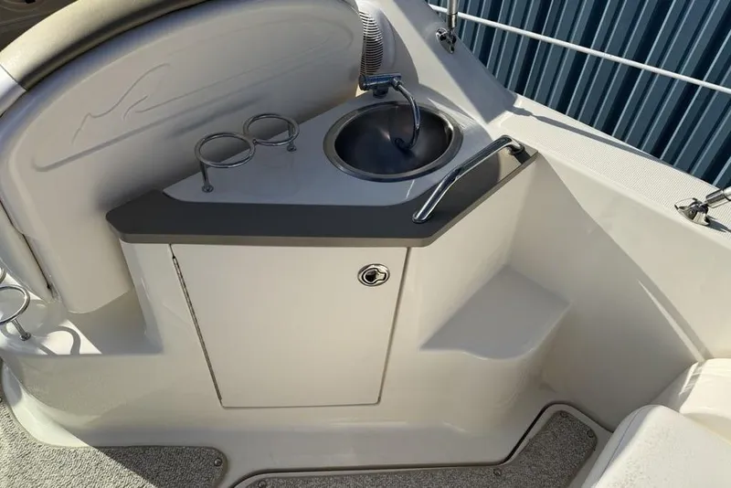 Slide: The Image of 2007 Sea Ray Sundancer 540 boat sink area with cup holders and storage. - 20