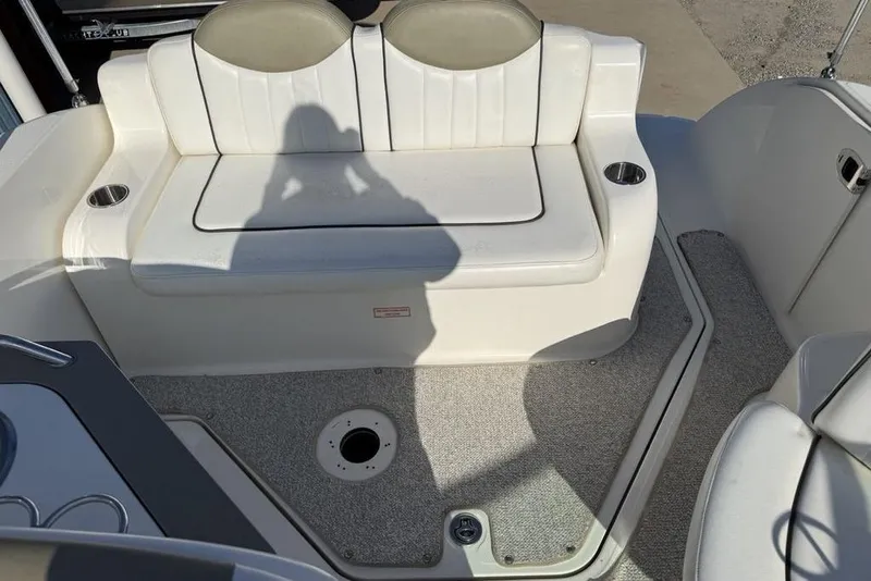Slide: The Image of 2007 Sea Ray Sundancer 540 boat seating area with cup holders and carpeted floor. - 24
