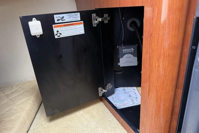 Slide: The Image of Open cabinet in 2007 Sea Ray Sundancer 540 with Sirius Connect equipment inside. - 29