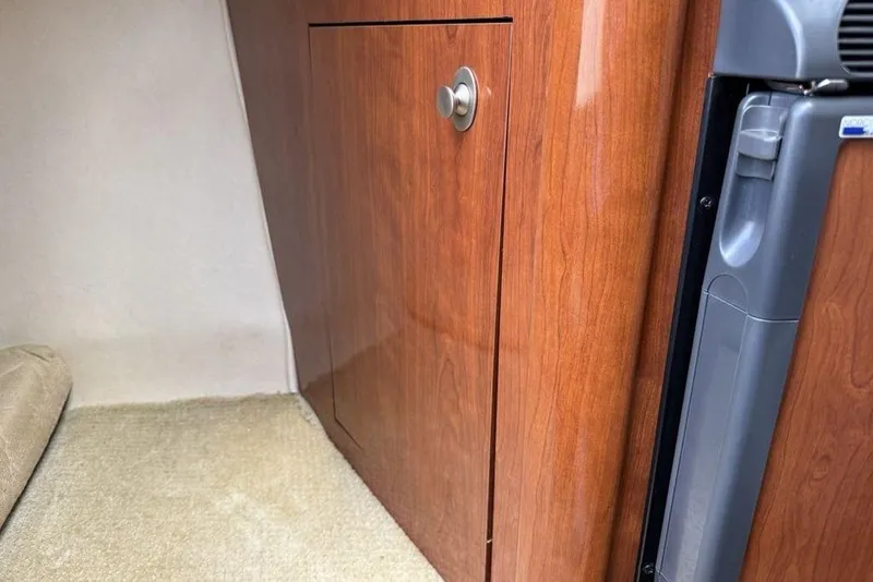 Slide: The Image of Interior of 2007 Sea Ray Sundancer 540 with wooden cabinetry and carpeted flooring. - 30