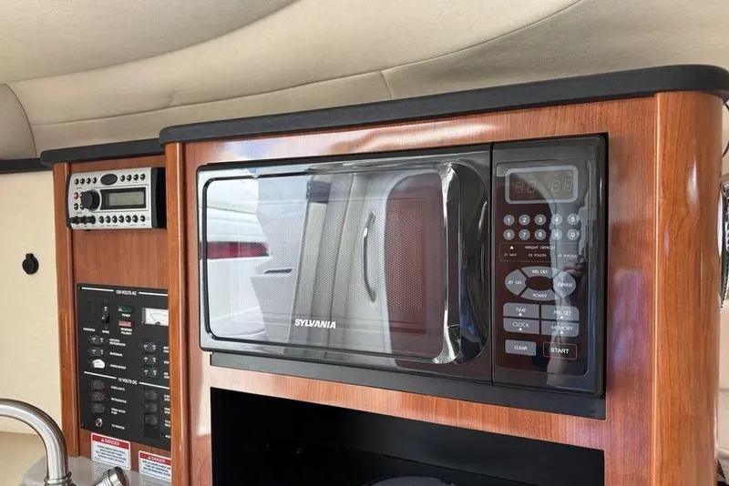 Slide: The Image of 2007 Sea Ray Sundancer 540 interior with Sylvania microwave and control panel. - 33