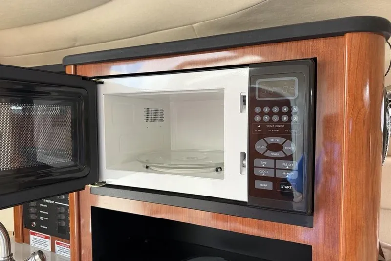 Slide: The Image of Microwave inside 2007 Sea Ray Sundancer 540 yacht, featuring wood paneling and digital controls. - 37