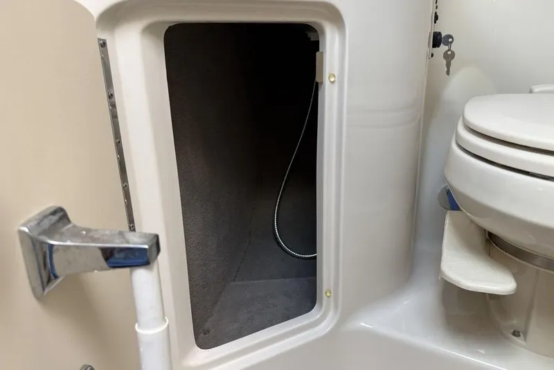 Slide: The Image of 2007 Sea Ray Sundancer 540 bathroom with open storage compartment and toilet. - 38