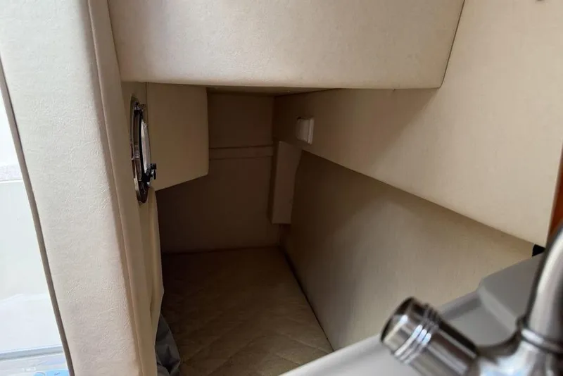 Slide: The Image of 2007 Sea Ray Sundancer 540 interior cabin with beige walls and a small window. - 41