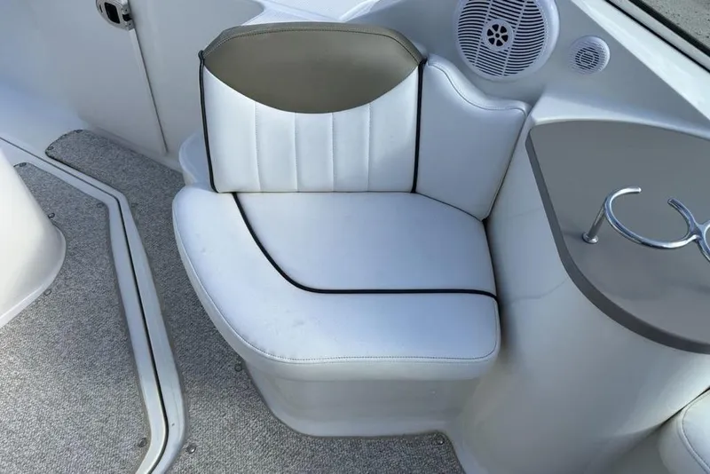 Slide: The Image of White leather seating on 2007 Sea Ray Sundancer 540 yacht, featuring integrated speaker and cup holder. - 21