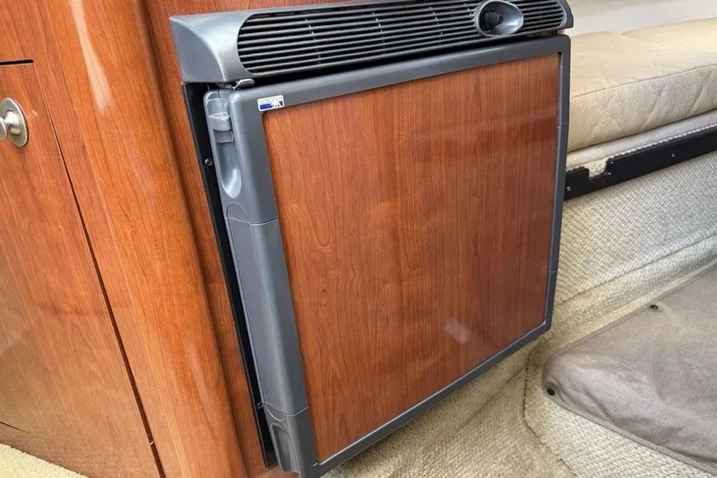 Slide: The Image of Wood-paneled mini fridge in 2007 Sea Ray Sundancer 540 yacht interior. - 27