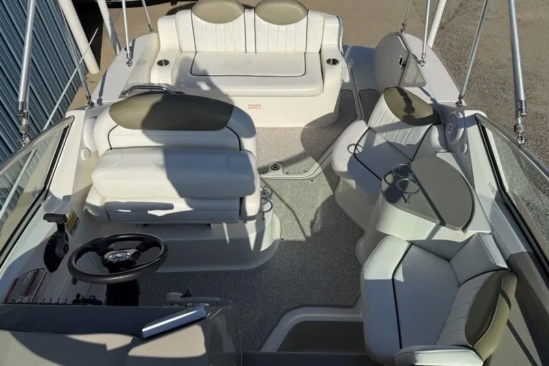 Slide: The Image of 2007 Sea Ray Sundancer 540 interior with plush seating and modern steering wheel. - 4