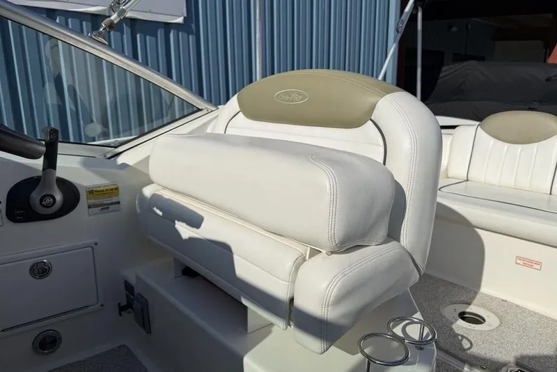 Slide: The Image of 2007 Sea Ray Sundancer 540 helm seat with white upholstery and steering wheel. - 7